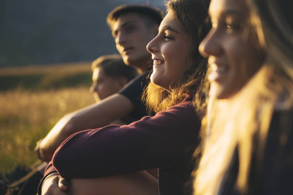 Row of teens watching the sunset