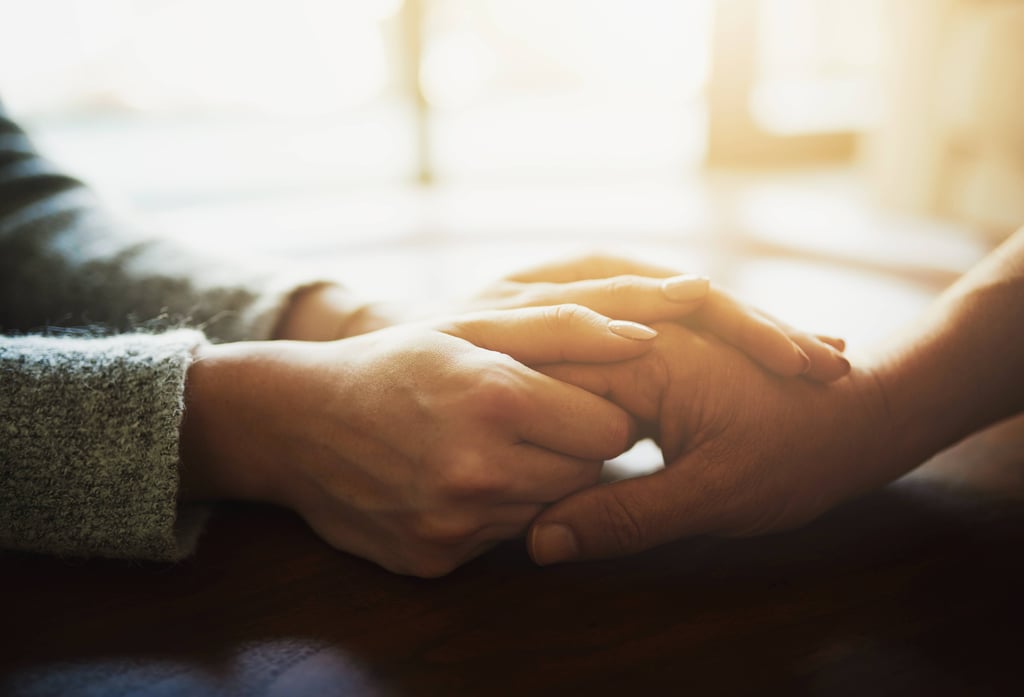 Woman holding her elderly mothers hand