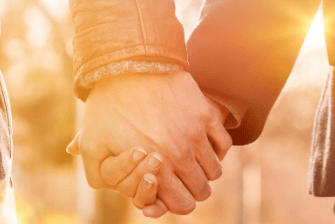 Couple holding hands with a sun flare filter applied